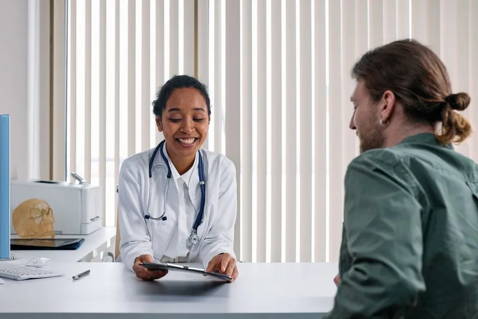 A doctor and patient talking together in a bright clinic