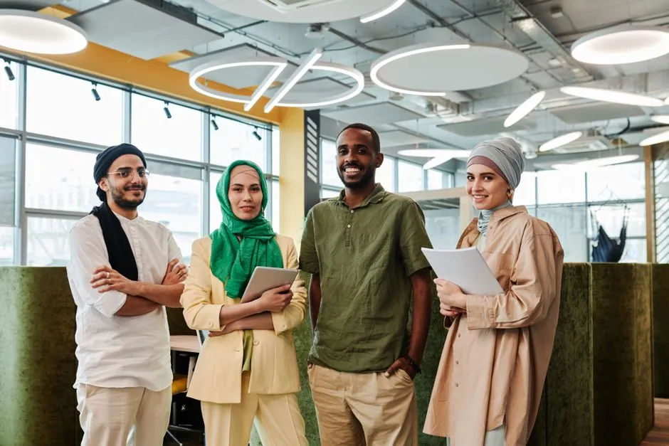 A diverse group of allied health professionals standing together in a bright workspace